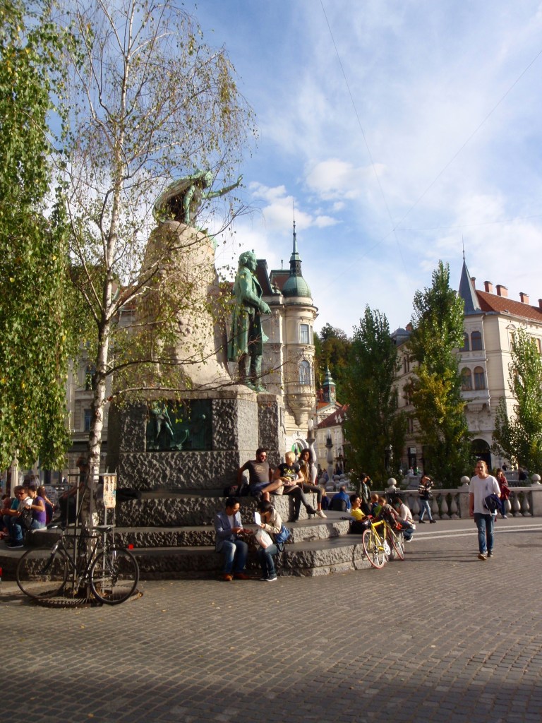 Downtown Ljubljana, where the well known statue of Joze Plecnik (with his muse above) catches the autumn evening light.