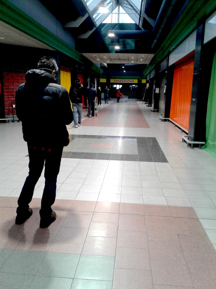 Waiting in line to enter a grocery store during Covid lockdown in Italy, 2020
