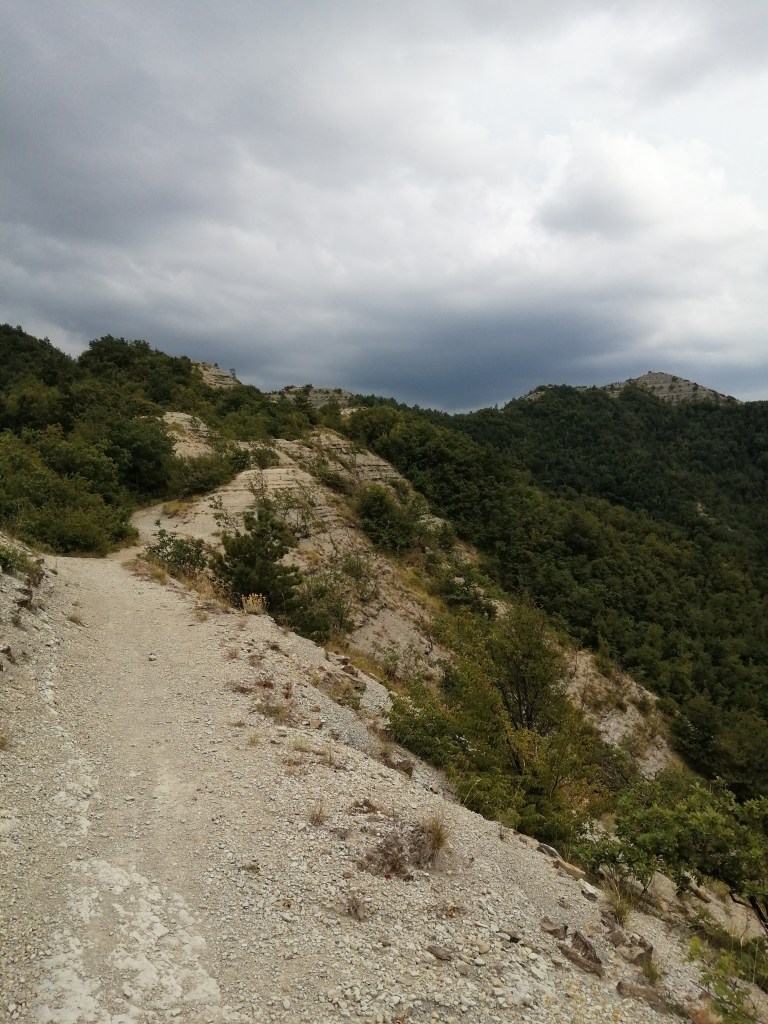 Dark, brooding skies and trail through calanchi