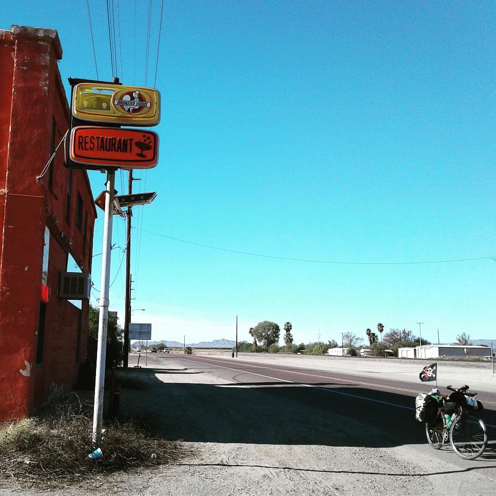 Bicycle with a pirate flag on the side of the road in small town America.