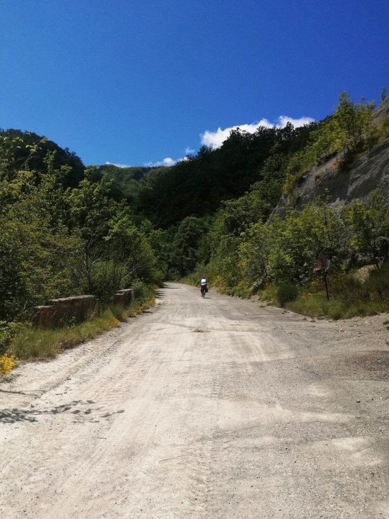 Two bike tourists on the closed E-45 highway outside of Bagno di Romagna. Nothing but sky and trees.